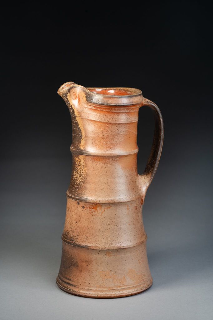 A tall, straight-walled wood-fired pitcher