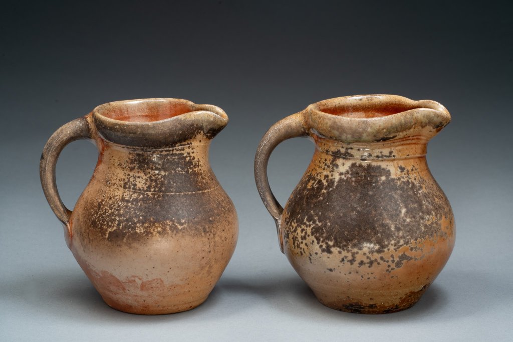 Two small wood-fired pitchers